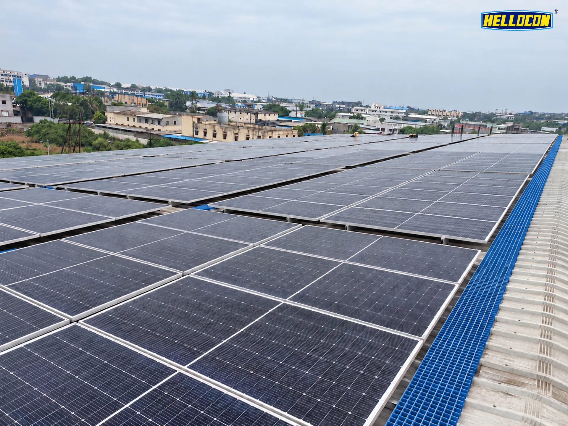 Monocrystalline panels and a blue walkway on a factory roof at the HELLOCON 200 kWp industrial rooftop plant in Khordha